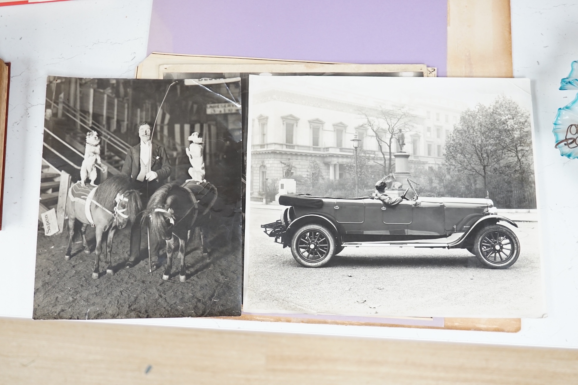 A group of vintage black and white photographs; Steam ship 'Atrato', twin-hulled steamship, Circus horses, Circus pony/dog act & vintage car on a London street, largest 31 x 39cm, unframed. Condition - fair